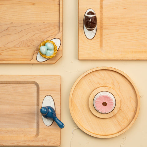 Wooden boards with various minis on a beige surface