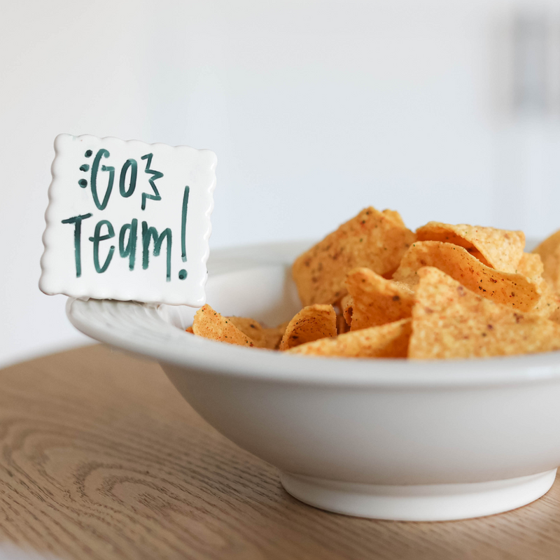 simple scallop to write your message  of "go team" on a pinstripes baby bowl filled with chips