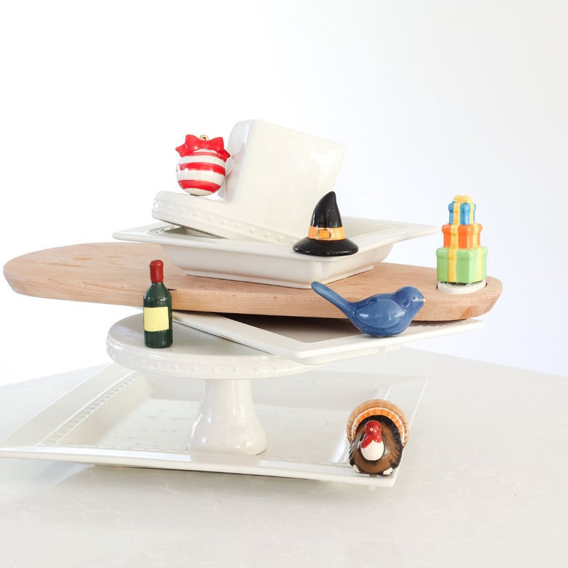 birthday present mini with witch hat, ornament, wine, bluebird of happiness and wine minis on square platter, cake stand and wood board