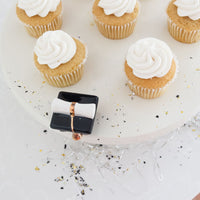 graduation hat on cake stand with cupcakes