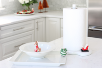 pinstripes melamine paper towel holder and santa sleigh mini and green and white ornament and rudolph the red-nosed reindeer mini in a white kitchen
